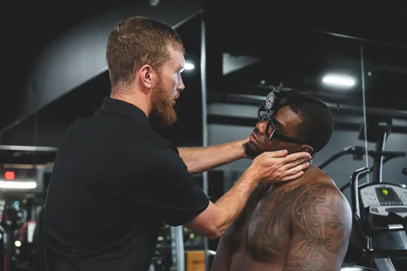 Matt assessing an athlete's head and neck position